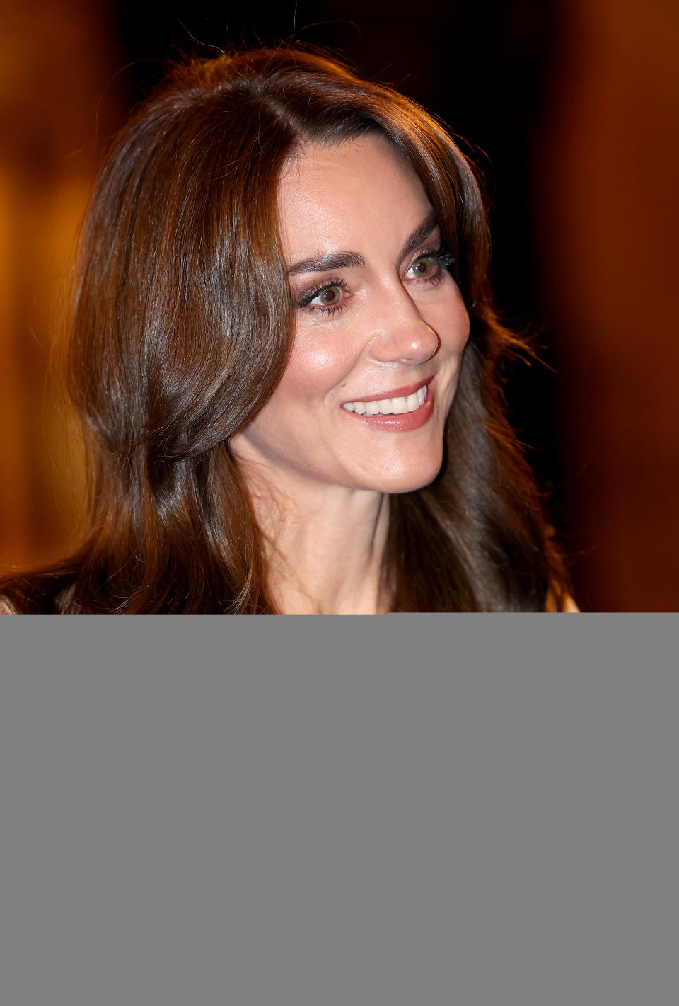 Kate Middleton with long wavy hair.