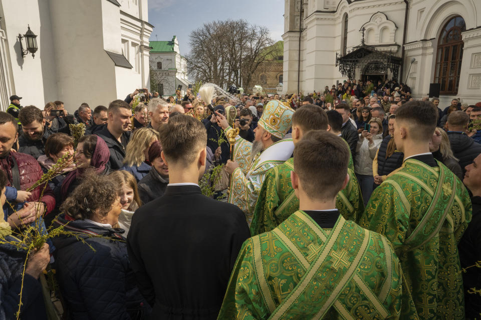 Metropolitan Epiphanius, head of the Orthodox Church of Ukraine blesses worshipers as they gather to celebrate Palm Sunday at Kiev-Pechersk Lavra monastery, Ukraine's most revered Orthodox site in Kyiv, Ukraine, Sunday, April 9, 2023. (AP Photo/Adam Pemble)