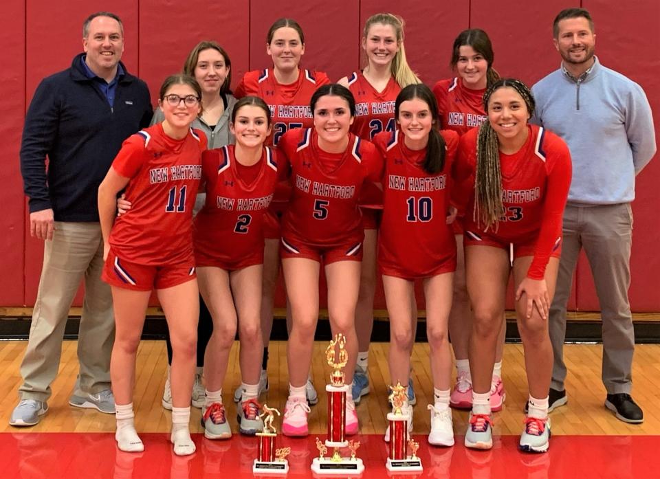 The New Hartford Spartans pose with their hardware after winning Baldwinsville's Bill Middleton Tip-Off Tournament championship with a victory over the host school Saturday.