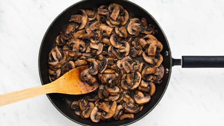 Mushrooms and garlic in frying pan