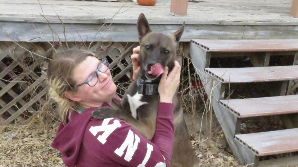 Amber Huffman shares a moment with her dog, Piper. Her family has had to leave two dogs at the house where they’ve lived for four years, after the city shut off the power and they couldn’t take them to a friend’s house where they’re currently staying.