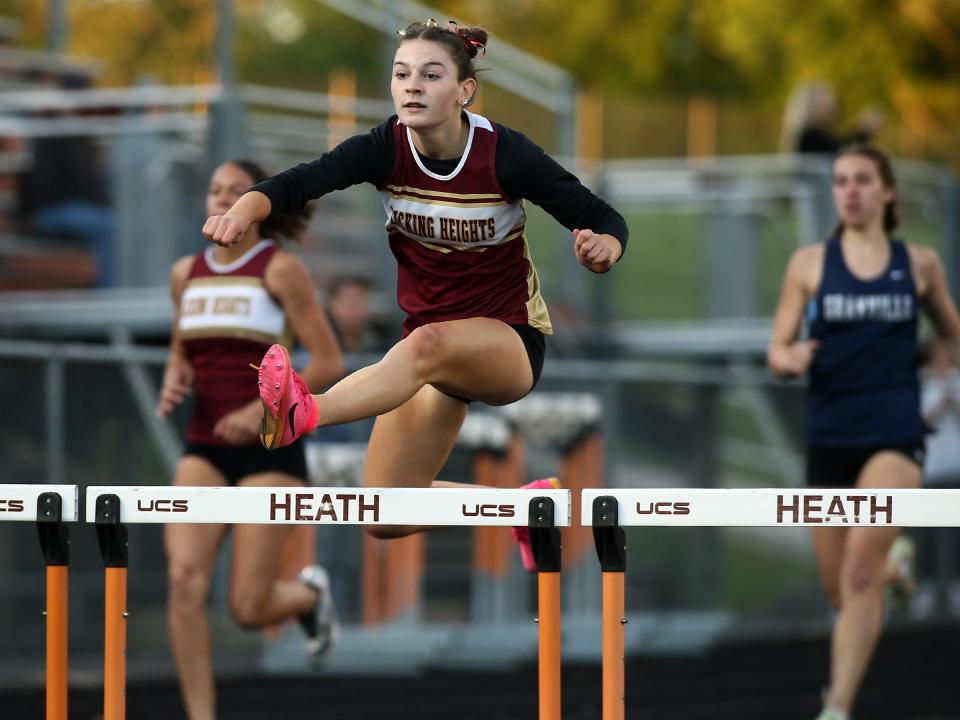 Licking Heights' Emma French leads in the Buckeye Division 300 hurdles during the Licking County League championships at Heath on Friday, May 10, 2024.