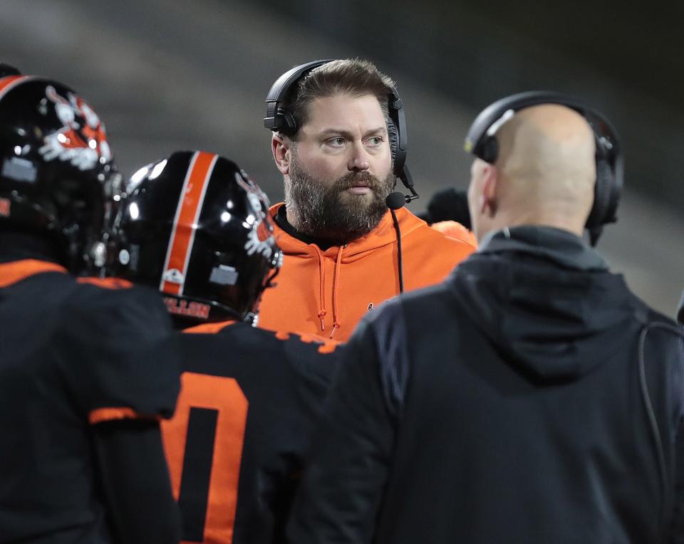 Massillon head coach Nate Moore huddles with his team during this OHSAA Division II state semifinal game Friday, Nov. 25, 2022 at the University of Akron.