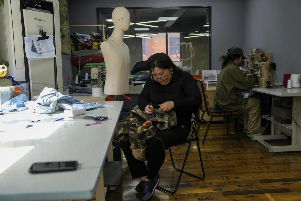 Workers labor at a workshop for Times Remake, a Shanghai-based brand that takes secondhand clothes and refashions them into new garments in Shanghai on March 18, 2024. (AP Photo/Ng Han Guan)