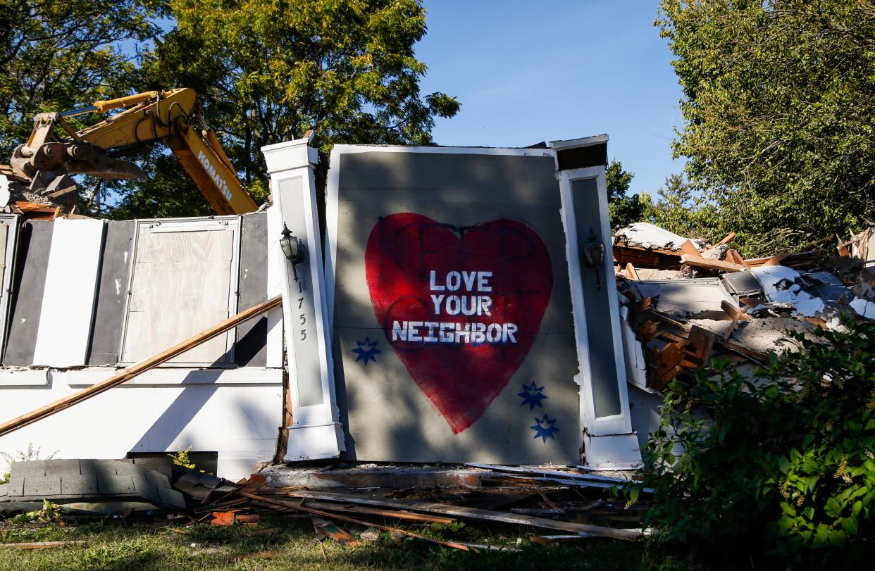 An excavator tears down a house at the corner of Sunshine Street and National Avenue on Tuesday, Oct. 4, 2022. The house is at the center of battle over a proposed development between a group of developers and the University Heights Neighborhood Association.