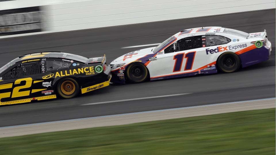 Drivers Brad Keselowski (2) and Denny Hamlin (11) race bumper-to-bumper during a NASCAR Cup Series auto race, Sunday, Aug. 2, 2020, at the New Hampshire Motor Speedway in Loudon, N.H. (AP Photo/Charles Krupa)