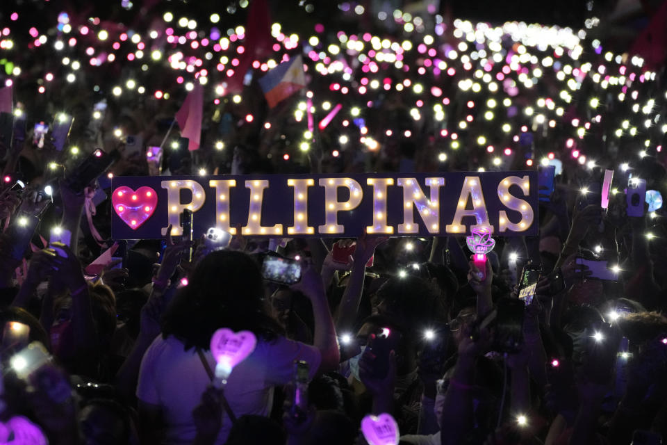 Supporters of Vice President Leni Robredo and running mate Senator Francis "Kiko" Pangilinan hold a Philippines sign during her presidential campaign rally in Pasay City, Philippines on April 23, 2022. The winner of May 9, Monday's vote will inherit a sagging economy, poverty and deep divisions, as well as calls to prosecute outgoing leader Rodrigo Duterte for thousands of deaths as part of a crackdown on illegal drugs. (AP Photo/Aaron Favila)