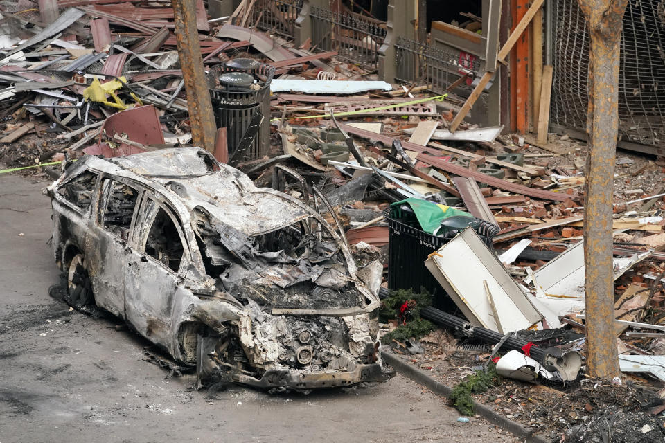 A vehicle destroyed in a Christmas Day explosion remains on the street Tuesday, Dec. 29, 2020, in Nashville, Tenn. Officials have named 63-year-old Anthony Quinn Warner as the man behind the bombing in which he was killed, but his motive remains elusive. (AP Photo/Mark Humphrey)