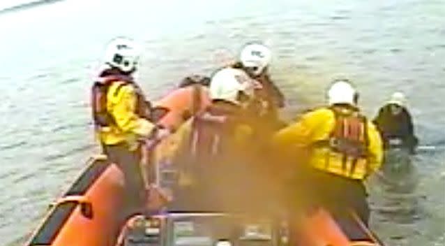 The crew find the woman on top of a car completely submerged by the tide. Source: RNLI