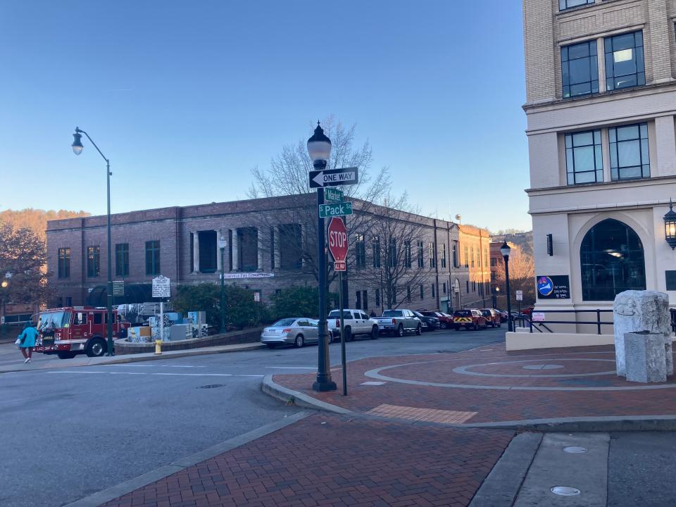 Near Pack Square Plaza, looking toward the intersection of Court Plaza and South Market Street, the side of the city's Municipal Building is lined with cars on Nov. 29, 2023.