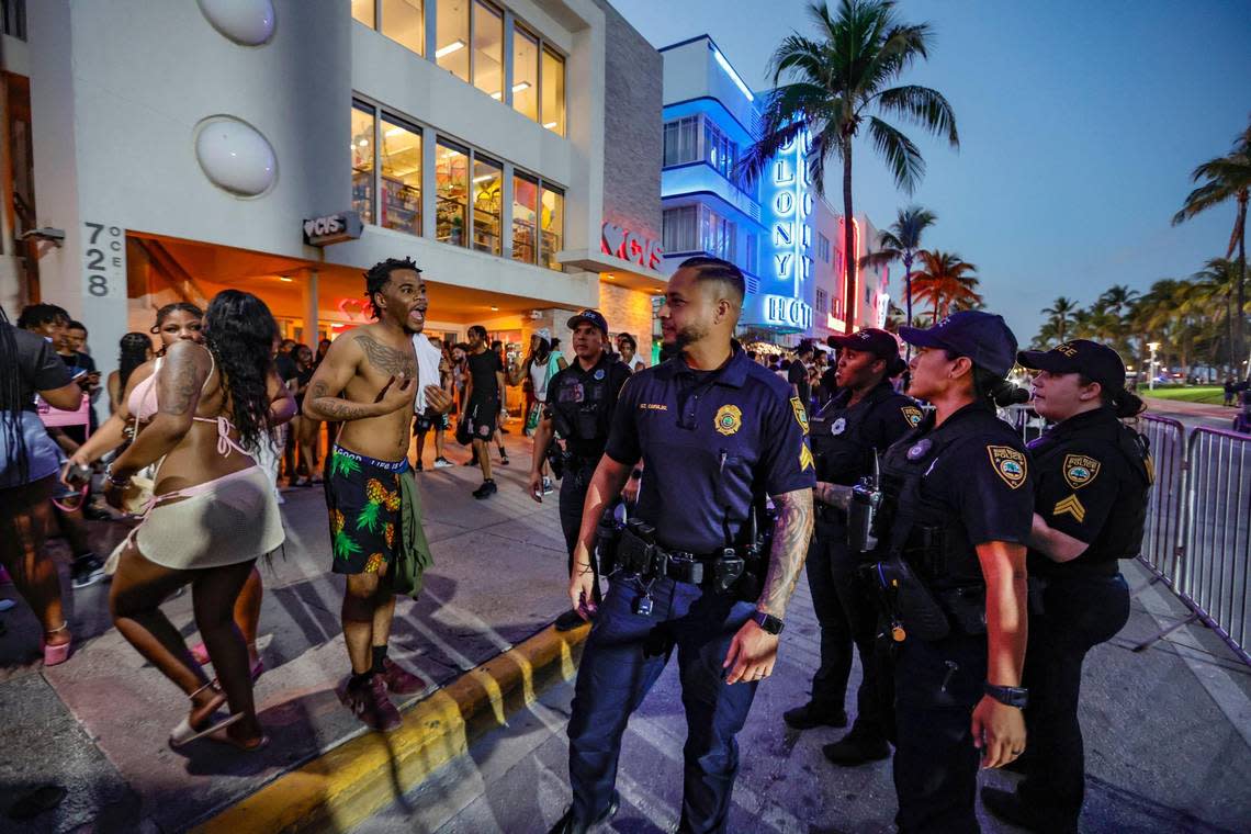 A man speaks with Miami Beach police officers after they confronted him on Ocean Drive during spring break on Miami Beach, Florida on Sunday, March 17, 2024.