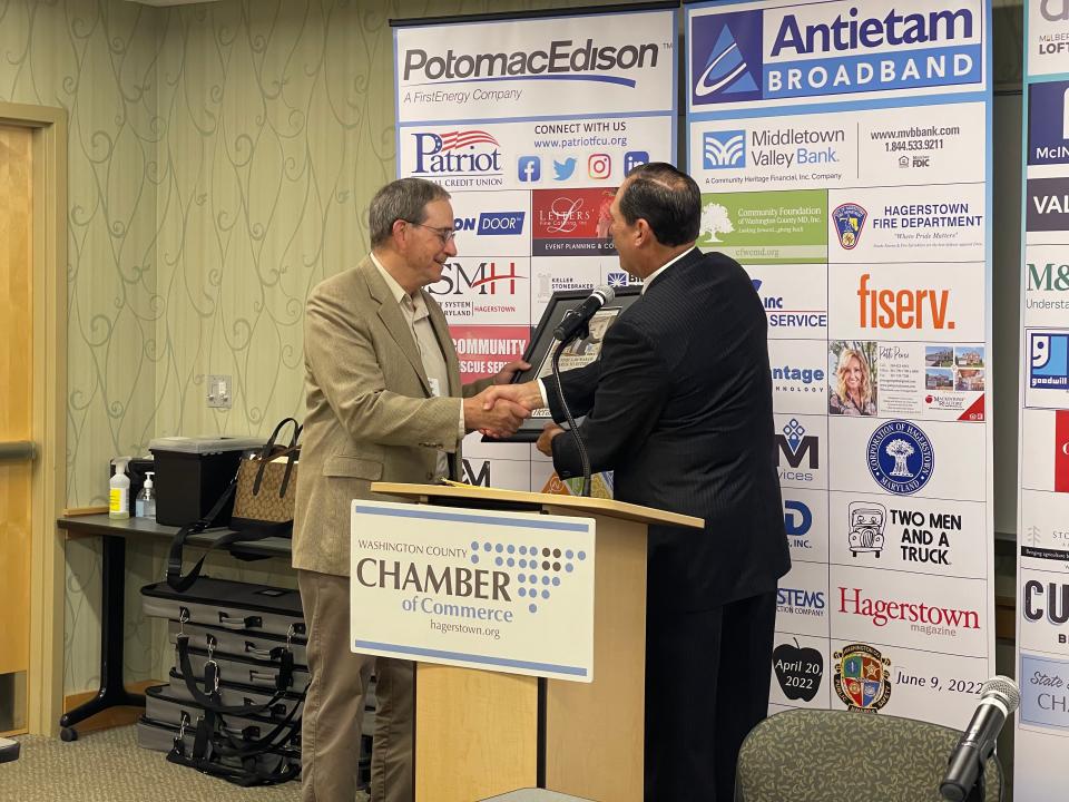 Washington County Chamber of Commerce President Paul Frey (right) awards Sen. George Edwards, R-Allegany/Garrett/Washington (left), for his 40 years of service in Western Maryland during the county delegation's annual post-legislative forum on May 3, 2022.