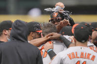 Baltimore Orioles starting pitcher John Means is mobbed by teammates and has water dumped on him after he threw a no-hitter baseball game against the Seattle Mariners, Wednesday, May 5, 2021, in Seattle. The Orioles won 6-0. (AP Photo/Ted S. Warren)