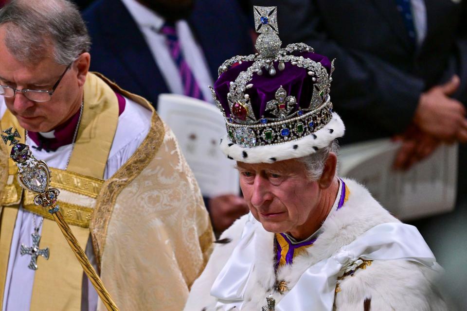 Britain's King Charles III wears the Imperial State Crown and holds the Sovereign's Sceptre as he leaves after his coronation ceremony, at Westminster Abbey, in London, Saturday, May 6, 2023. (Mark Large/Pool Photo via AP)