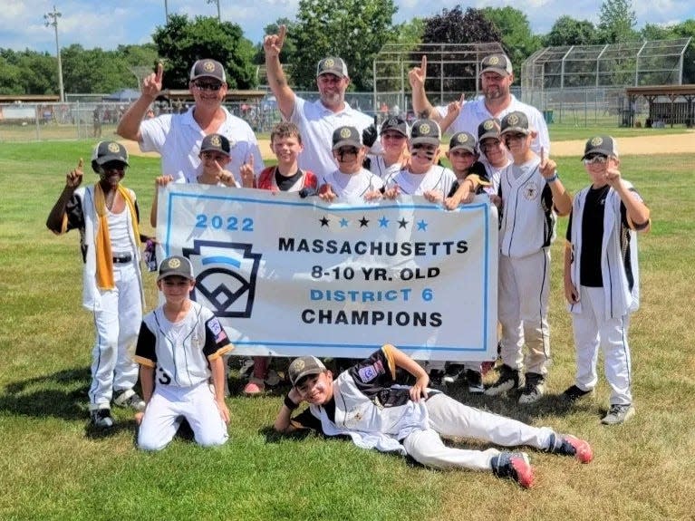 The Taunton West Little League 10U team with their banner after winning the Division 6 championship.