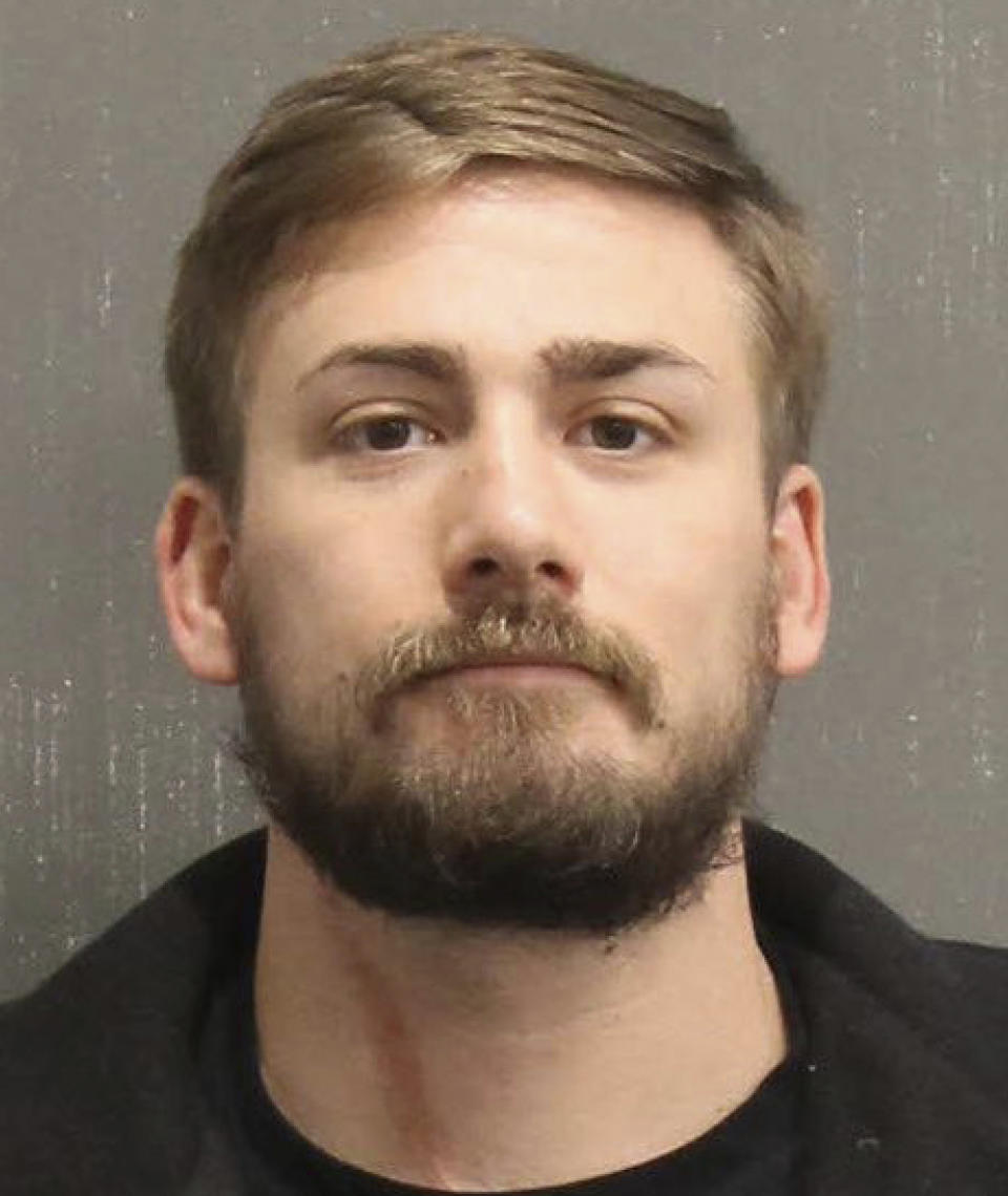 This booking photo released by the Metro Nashville, Tenn., Police Department, shows Eric Gavelek Munchel. A Washington, D.C., judge on Wednesday, Feb. 17, 2021, ordered that a Georgia woman and her Tennessee son remain jailed pending trial on charges for their involvement in the Jan. 6 riot at the U.S. Capitol. Lisa Eisenhart is accused of breaking into the Capitol with her son, Eric Munchel, who was photographed carrying flexible plastic handcuffs in the Senate chamber. (Metro Nashville Police Department via AP)