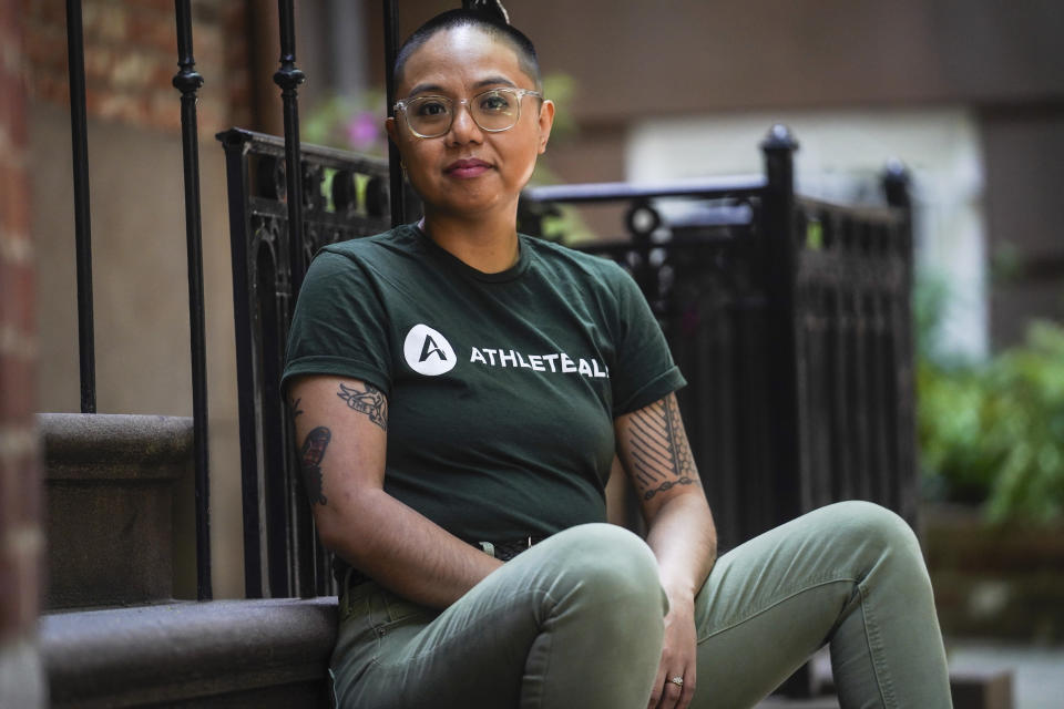 AC Dumlao, chief of staff for Athlete Ally, a group that advocates on behalf of LGBTQ+ and intersex athletes, and a transgender, nonbinary Filipino American, sits for a portrait in New York on Wednesday, May 31, 2023. They will be one of the grand marshals for the 2023 NYC Pride March. (AP Photo/Bebeto Matthews)