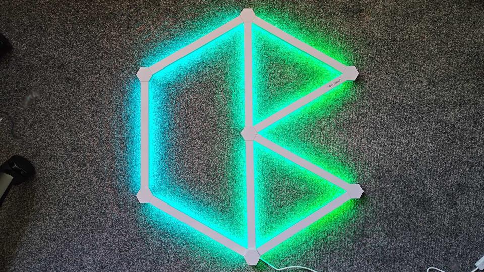 Nanoleaf Lines set up sitting on floor with green lights