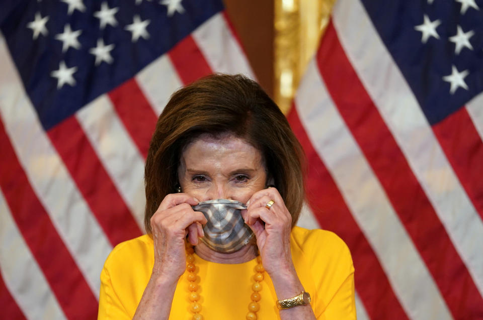 Speaker of the House Nancy Pelosi puts on her face mask to protect from the coronavirus disease (COVID-19) after taking part in a ceremonial swearing-in for Rep. Mike Garcia (R-CA) in Washington, U.S., May 19, 2020. REUTERS/Kevin Lamarque     TPX IMAGES OF THE DAY