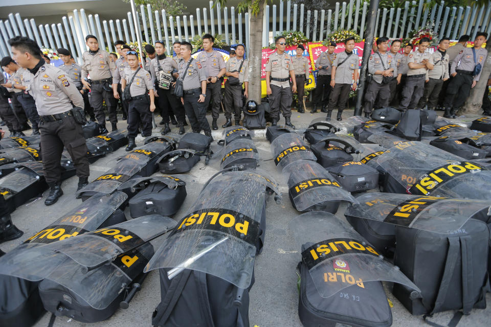 Riot police are deployed in anticipation of protests outside the General Election Supervisory Board building in Jakarta, Indonesia, Tuesday, May 28, 2019. Four top Indonesian officials, including two Cabinet ministers and the national spy chief, were targeted for assassination as part of a plot possibly linked to last week's election riots, police said Tuesday. (AP Photo/Tatan Syuflana)