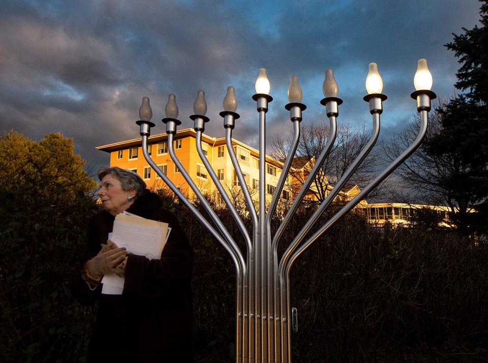 Phyllis Halpern, president of Jewish Residents Council at Ann's Choice, the Erickson Senior Living Community, in Warminster, walks away after flicking the switch during the ceremonial lighting of the menorah in celebration of Hanukkah, on Monday, Nov. 29, 2021.