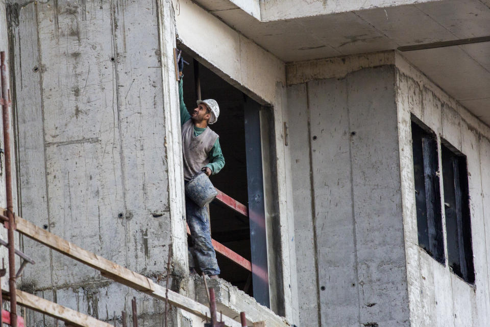 A Palestinian laborer works at a construction site in the east Jerusalem settlement of Ramat Shlomo Tuesday, Nov. 10, 2020. Israel's West Bank settlements could provide a key test case for U.S.-Israel relations during the Biden presidency. Israel has an opportunity to push through a final frenzy of construction plans during the last two months of the settlement-friendly Trump administration. But doing so would risk antagonizing the incoming president, who has a long history of opposition to Israeli construction in the occupied West Bank. (AP Photo/Ariel Schalit)