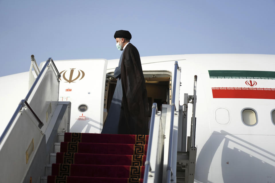 Iranian President Ebrahim Raisi boards his plane departing Tehran's Mehrabad airport for a trip to Oman, Monday, May, 23, 2022. (AP Photo/Vahid Salemi)