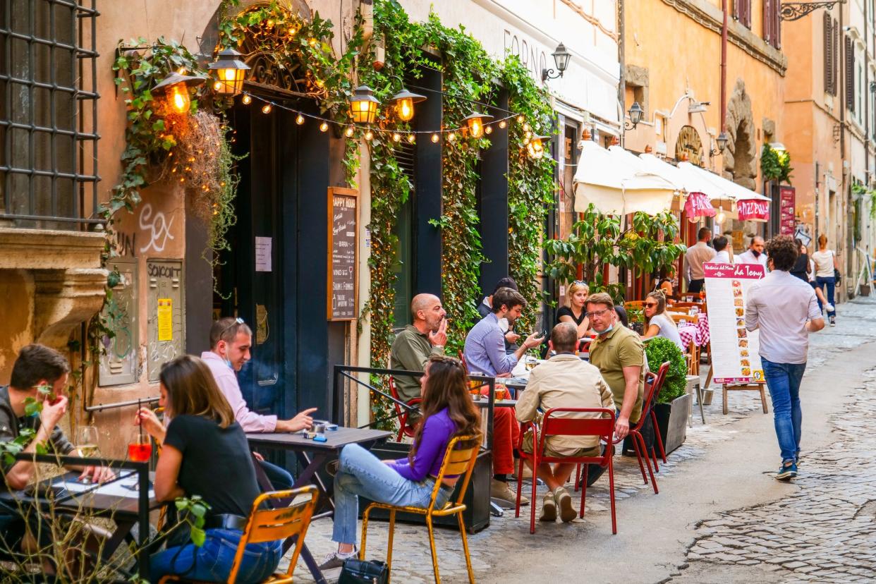 Rome, Italy, May 22 -- Some persons sitting outside a bar enjoy an aperitif in Trastevere in Rome during the slow reopening to a normal life after the lockdown due to the Covid-19. Image in HD format.