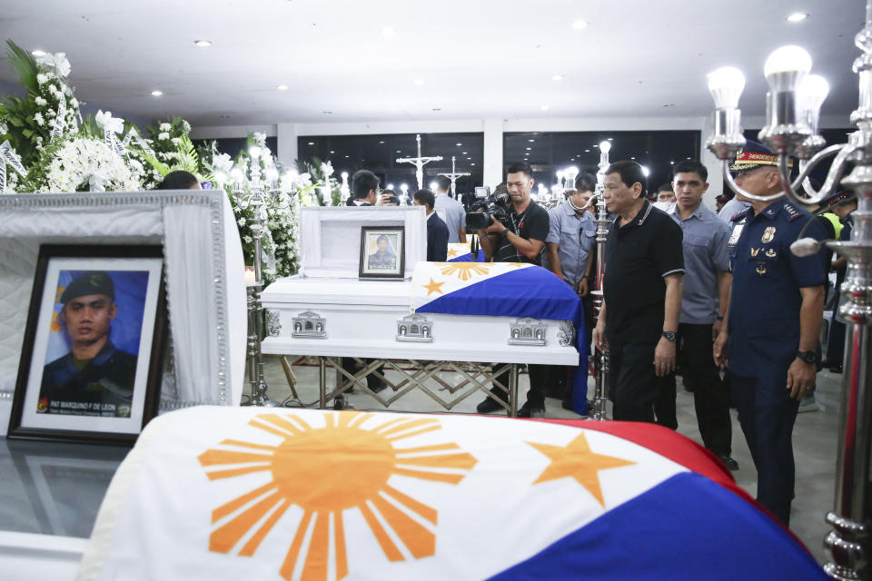 In this photo provided by the Presidential Malacanang Palace on Saturday July 20, 2019, Philippine President Rodrigo Duterte visits the wake for slain police officers at Camp Lt. Col. Francisco C. Fernandez Jr. in Sibulan, Negros Oriental, in Central Philippines. On Thursday, July 25, 2019, President Rodrigo Duterte said he raised a reward of 3 million pesos ($59,000) out of anger for what he described as the Islamic State group-style killings of the officers on July 18 in Negros Oriental province. Communist guerrillas claimed responsibility for the attack but denied torturing the police officers. (Ace Morandante/Presidential Photo Via AP)