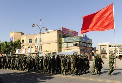 Chinese soldiers are seen marching behind a flag in Kashgar, China's farwest Xinjiang region, in 2009. China on Monday blamed Muslim separatist "terrorists" trained in neighbouring Pakistan for an outbreak of deadly violence and imposed heavy security in a bid to prevent further unrest