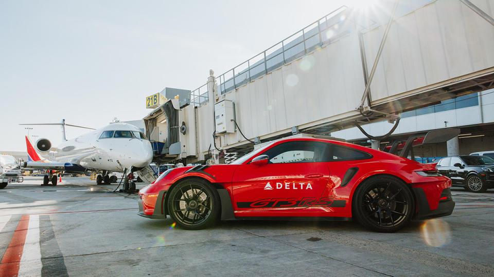 A sude view of the Porsche 911 GT3 RS Delta is using to shuttle passengers between connecting flights