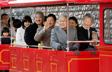 FILE PHOTO: Japan's Emperor Akihito (3rd R) and the royal family members, (R-L) Empress Michiko, Crown Princess Masako, Crown Prince Naruhito, Prince Akishino, Princess Kako, Princess Kiko and Prince Hisahito, ride on a solar-powered small locomotive as they visit Kodomonokuni, or Children's Land, marking the 50th anniversary of the royal marriage of Emperor Akihito and Empress Michiko, in Yokohama near Tokyo, December 19, 2009. REUTERS/Shuji Kajiyama/Pool/File Photo