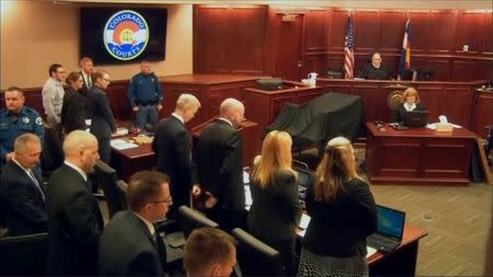 James Holmes (2nd L) stands at the start of his trial in Arapahoe County District Court in Centennial, Colorado in this still image captured from a pool video footage April 27, 2015. REUTERS/Reuters TV/Pool