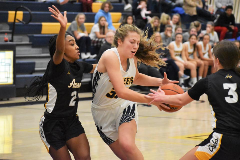 Mooresville's Ava Shafer drives inside as Avon's Nevaeh Wren (2) and Anna Levstek (3) close in on defense during the Pioneers' matchup with the Orioles on Dec. 6, 2022.