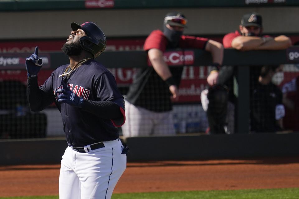 Cleveland Indians' Franmil Reyes looks to the sky as he arrives at home plate after hitting a home run against the Arizona Diamondbacks during the fourth inning of a spring training baseball game Wednesday, March 3, 2021, in Goodyear, Ariz. (AP Photo/Ross D. Franklin)