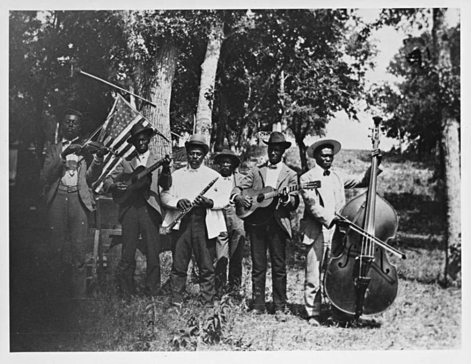 A band of men holding various instruments for Juneteenth