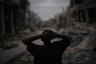 <p>A man pauses in a downtown street in earthquake-torn Port-au-Prince, Monday, Jan. 25, 2010. (Photo: Rodrigo Abd/AP) </p>