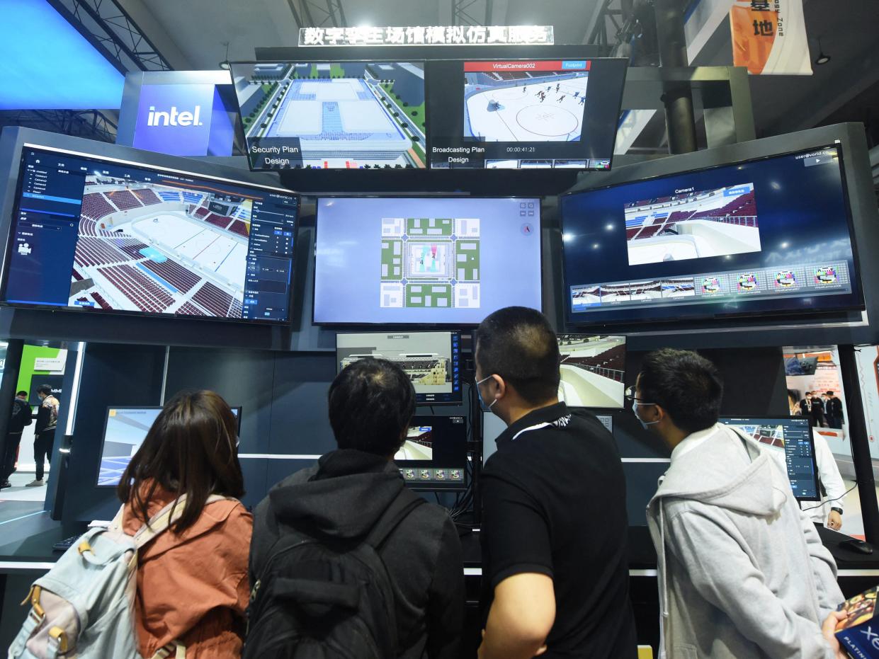 Visitors watch a digital twins simulation service system for sports venues by Intel at the Apsara Conference, a cloud computing and artificial intelligence (AI) conference, in Hangzhou, in China's eastern Zhejiang province on October 19, 2021.