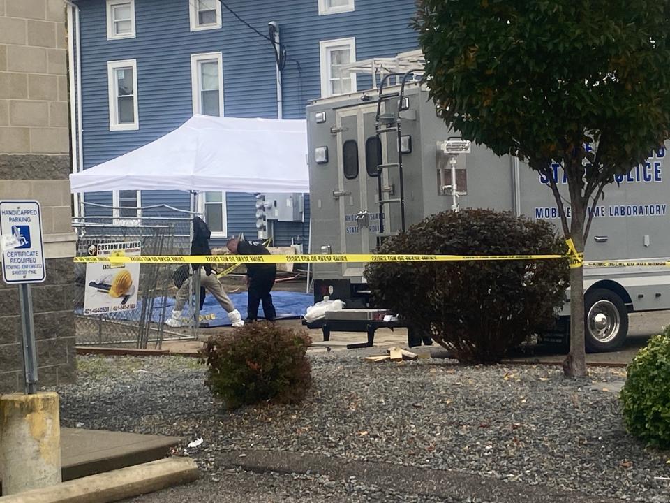 Central Falls and state police work at a construction site where skeletal remains were discovered Monday.