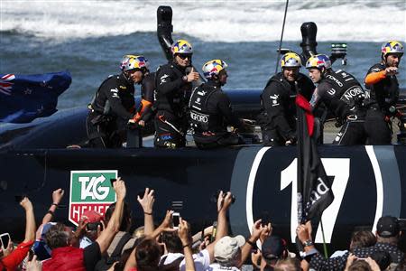 Oracle Team USA skipper James Spithill (3rd L) gives a thumbs up to spectators after the postponement of Race 13 of the 34th America's Cup yacht sailing race in San Francisco, California September 19, 2013. REUTERS/Stephen Lam