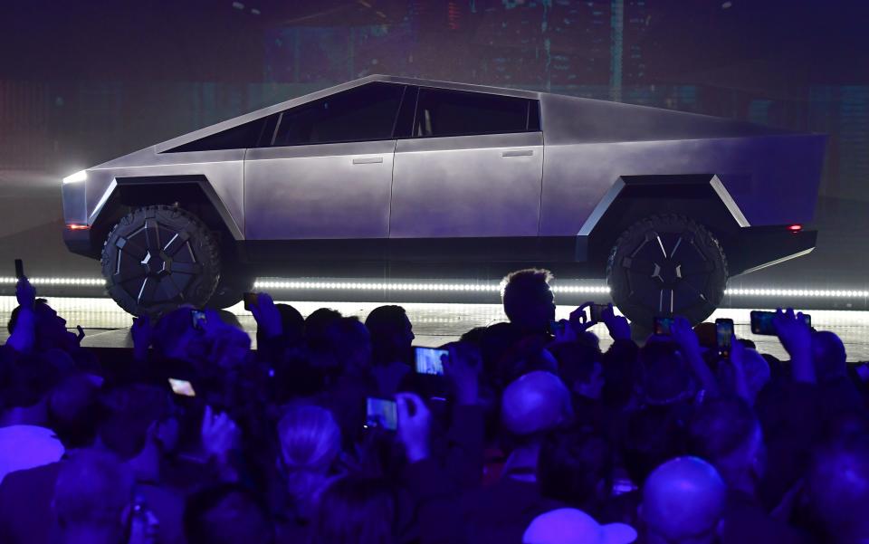 People take pictures of the newly unveiled all-electric battery-powered Tesla's Cybertruck at Tesla Design Center in Hawthorne, California on November 21, 2019. (Photo by FREDERIC J. BROWN / AFP) (Photo by FREDERIC J. BROWN/AFP via Getty Images)