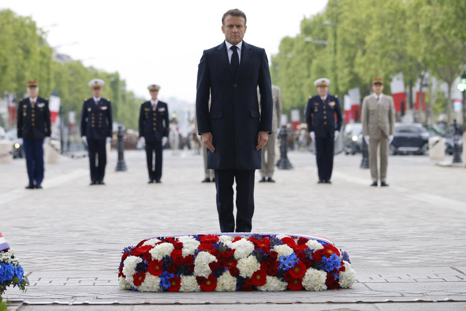 French President Emmanuel Macron stands after laying a wreath of flowers at the Tomb of the Unknown Soldier under the Arc de Triomphe, during a ceremony marking the 79th anniversary of the end of World War II, in Paris, Wednesday, May 8, 2024. (Johanna Geron, Pool via AP)