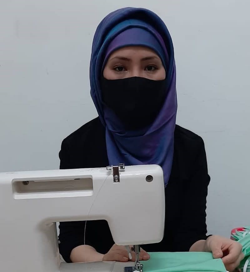 Anisa sewing a face mask in her own home. — Picture by Lilianne Fan.