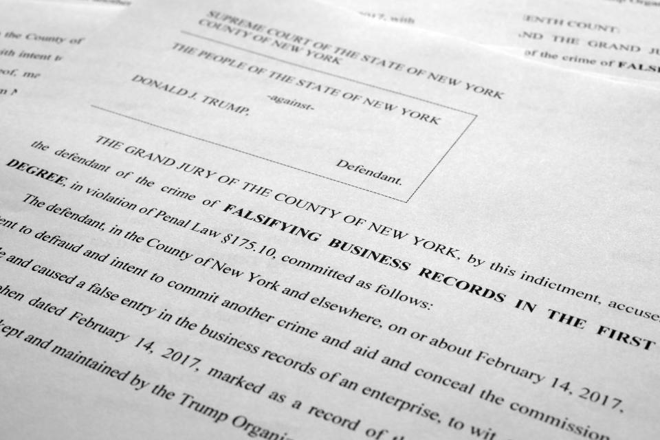 The indictment against former President Donald Trump is photographed Tuesday, April 4, 2023. Prosecutors say Trump conspired to "undermine the integrity of the 2016 election" through a series of hush money payments designed to stifle claims that could be harmful to his candidacy. That's according to the 34-count felony indictment. (AP Photo/Jon Elswick)