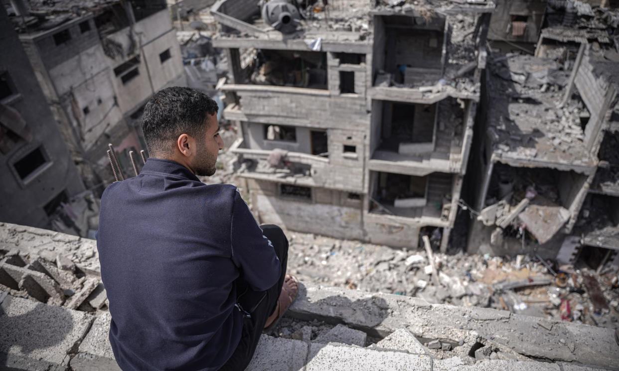 <span>A Palestinian sits on top of his house damaged by Israeli shelling.</span><span>Photograph: Saher Alghorra/ZUMA Press Wire/REX/Shutterstock</span>