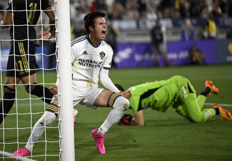 PASADENA, CA - JULY 04: LA Galaxy midfielder Riqui Puig (6) celebrates after scoring against Los Angeles FC goalkeeper John McCarthy, right, during the second half of a MLS soccer match at Rose Bowl Stadium on Tuesday, July 4, 2023 in Pasadena, CA. (Alex Gallardo/For the Times)