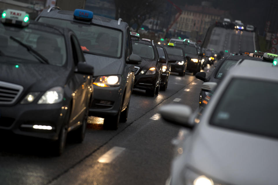 Taxi drivers slow the traffic during a protest in Lyon, central France, Thursday, Jan. 10, 2012. Taxi drivers across France were putting on the brakes to clog traffic, slow access to airports and force would-be passengers to find alternate transport in a strike over government efforts to deregulate the transportation industry. (AP Photo/Laurent Cipriani)