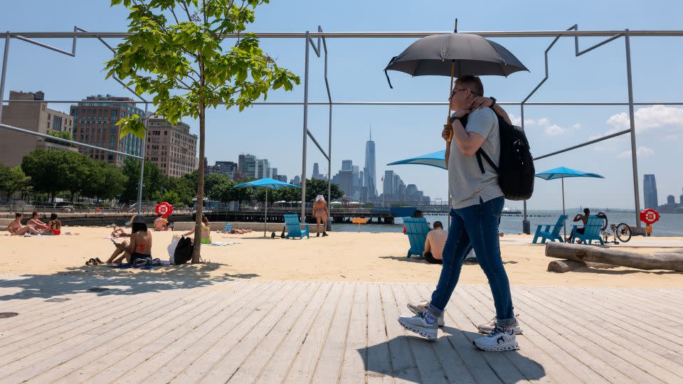 People relax at an artificial beach in Manhattan on a sweltering afternoon on the first full day of summer on June 21, 2024, in New York City. - Spencer Platt/Getty Images