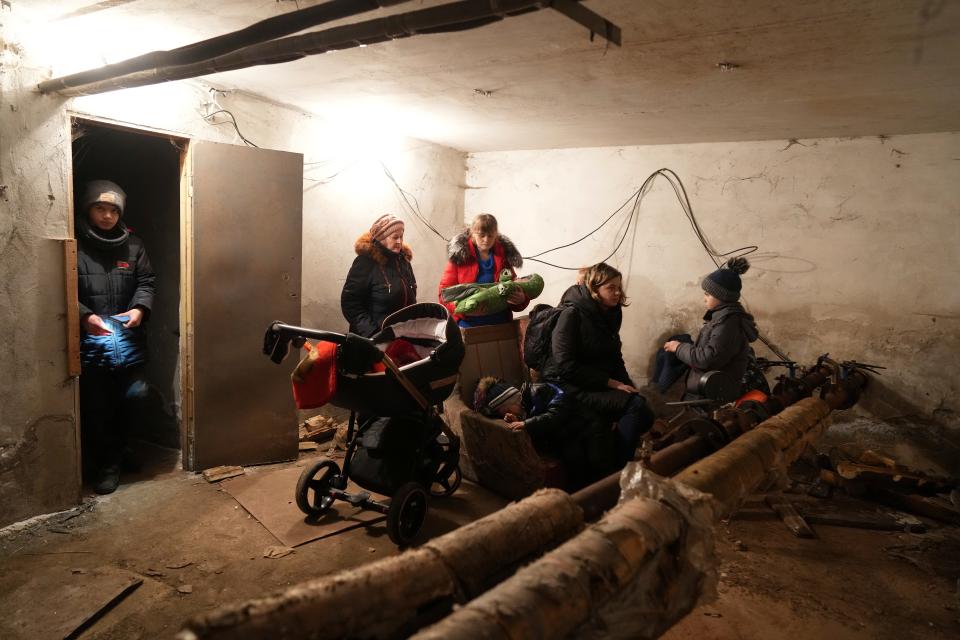 People gather in a shelter during Russian shelling, in Mariupol, Ukraine, on Thursday, Feb. 24, 2022.