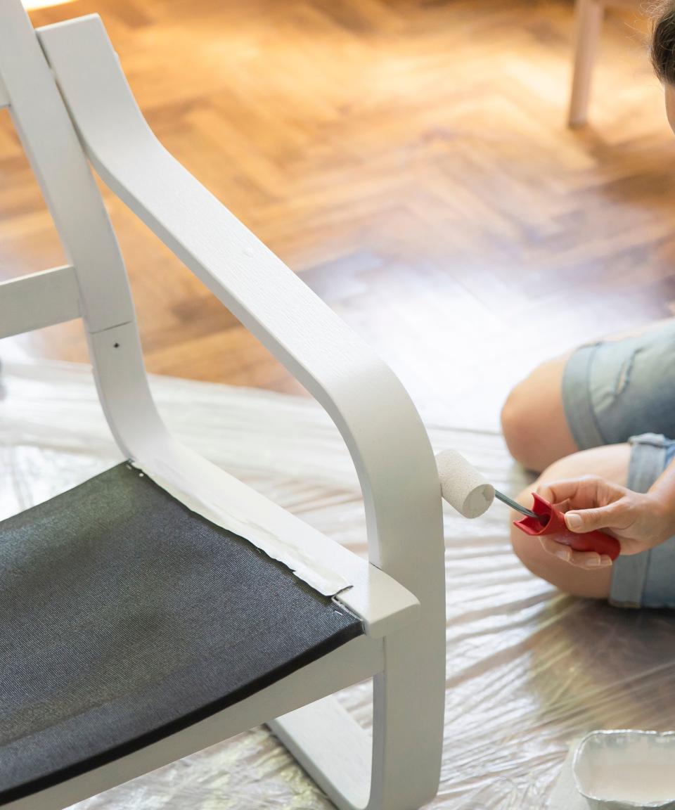 Someone painting a chair